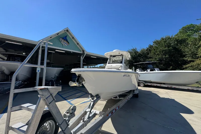 Slide: The Image of 2025 Solace 28 HCS boat on trailer outside a marine storage facility. - 5