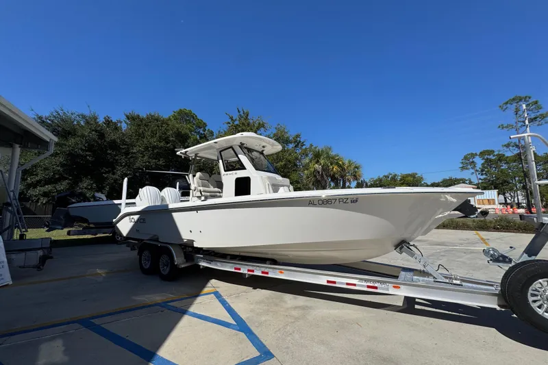 Slide: The Image of 2025 Solace 28 HCS boat on trailer under clear blue sky. - 8