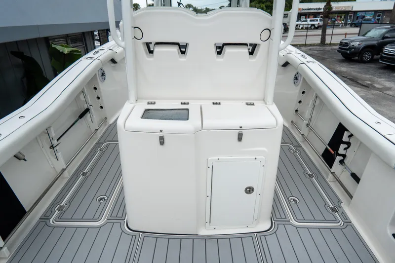 Slide: The Image of 2022 Tidewater 292 CC Adventure boat interior with storage compartments and sleek design. - 10