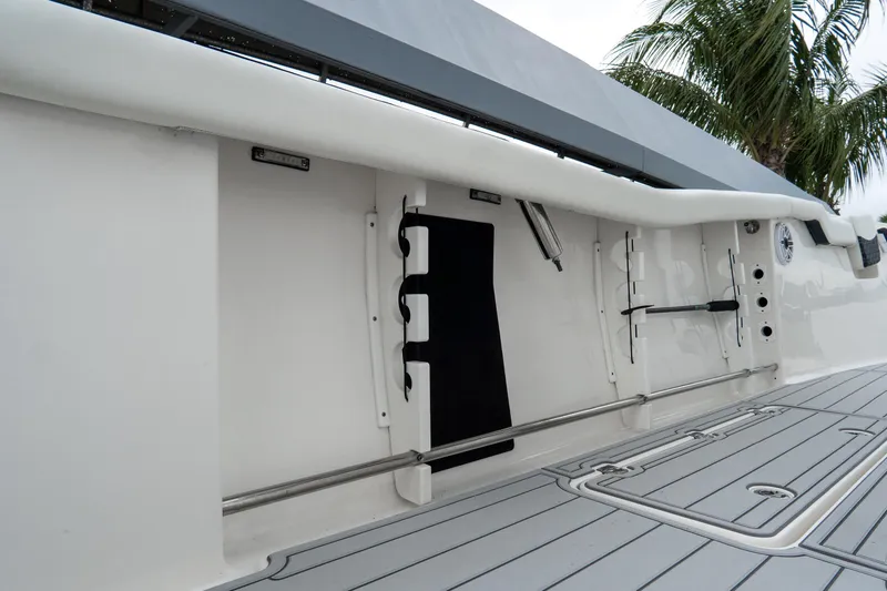 Slide: The Image of 2022 Tidewater 292 CC Adventure boat interior with rod holders and sleek design. - 13