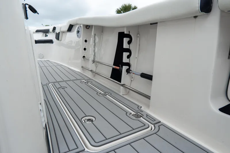 Slide: The Image of 2022 Tidewater 292 CC Adventure boat interior with sleek gray flooring and storage compartments. - 14