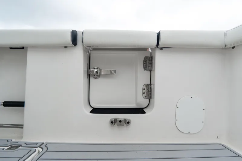 Slide: The Image of 2022 Tidewater 292 CC Adventure boat interior with secure hatch and cushioned seating. - 17