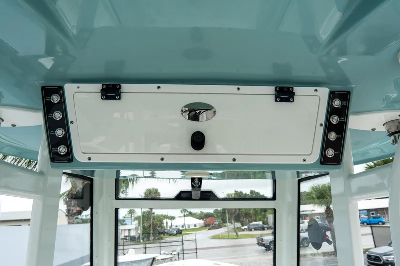 Slide: The Image of 2022 Tidewater 292 CC Adventure boat interior with control panel and storage compartment. - 24