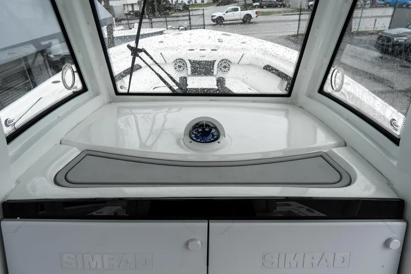 Slide: The Image of 2022 Tidewater 292 CC Adventure boat interior with Simrad electronics and compass. - 25