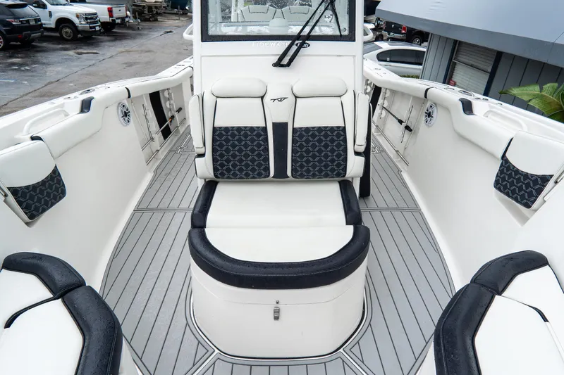 Slide: The Image of 2022 Tidewater 292 CC Adventure boat interior with cushioned seating and sleek design. - 29