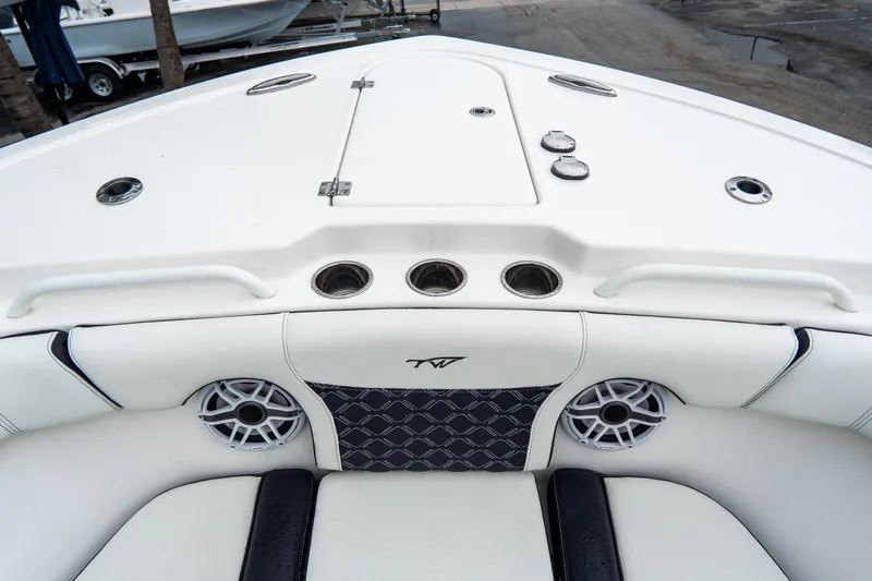 Slide: The Image of 2022 Tidewater 292 CC Adventure boat interior with speakers and storage compartments. - 32