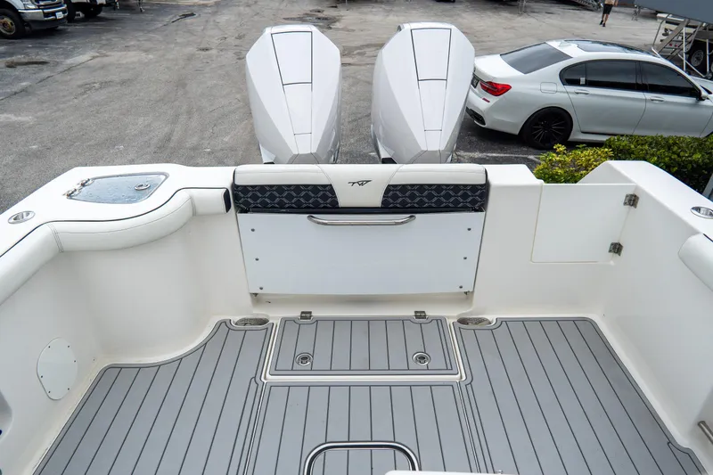 Slide: The Image of 2022 Tidewater 292 CC Adventure boat deck with dual engines and sleek design. - 9
