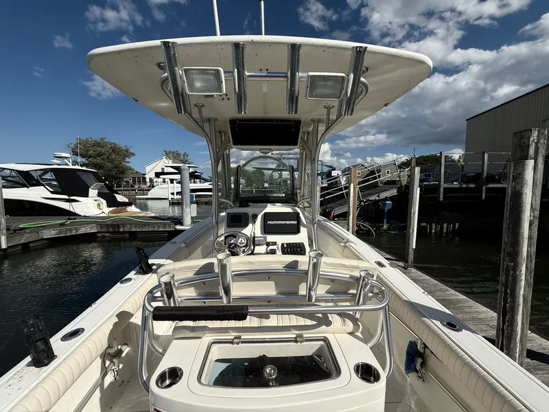 Slide: The Image of 2012 Mako 234 Center Console boat docked under a partly cloudy sky. - 4