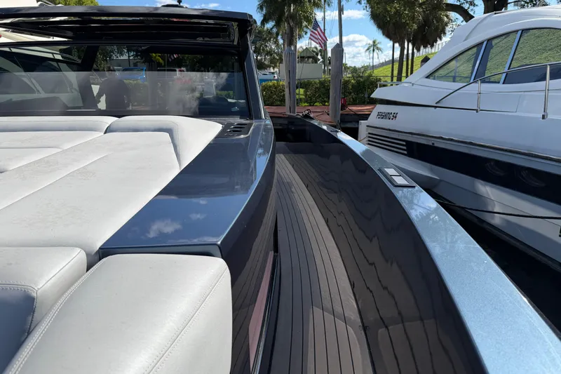 Slide: The Image of 2022 Vanquish VQ45 luxury yacht with sleek design and spacious deck, docked beside another vessel. - 17