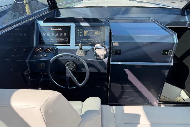 Slide: The Image of Cockpit of 2022 Vanquish VQ45 yacht with modern controls and steering wheel. - 18