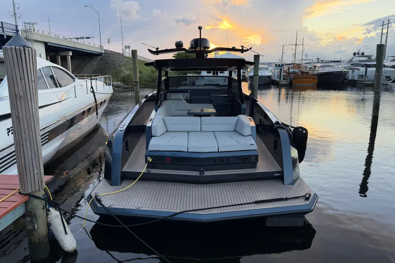 Slide: The Image of Luxury 2022 Vanquish VQ45 yacht docked at sunset in a serene marina. - 30