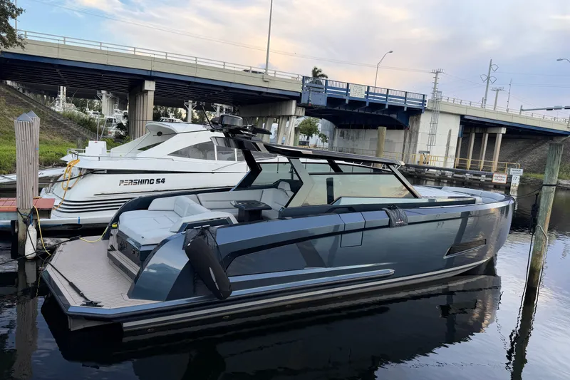 Slide: The Image of 2022 Vanquish VQ45 luxury yacht docked beside a Pershing S4 under a bridge. - 31