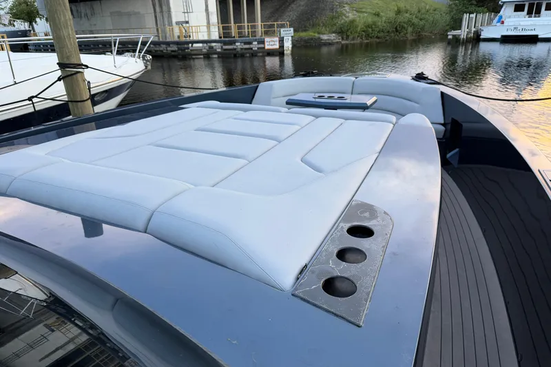 Slide: The Image of 2022 Vanquish VQ45 yacht with sleek deck design and luxurious seating by the water. - 32