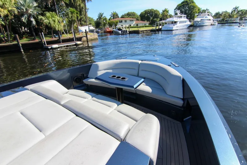 Slide: The Image of Luxurious 2022 Vanquish Yachts VQ45 with elegant seating on a serene waterfront. - 36