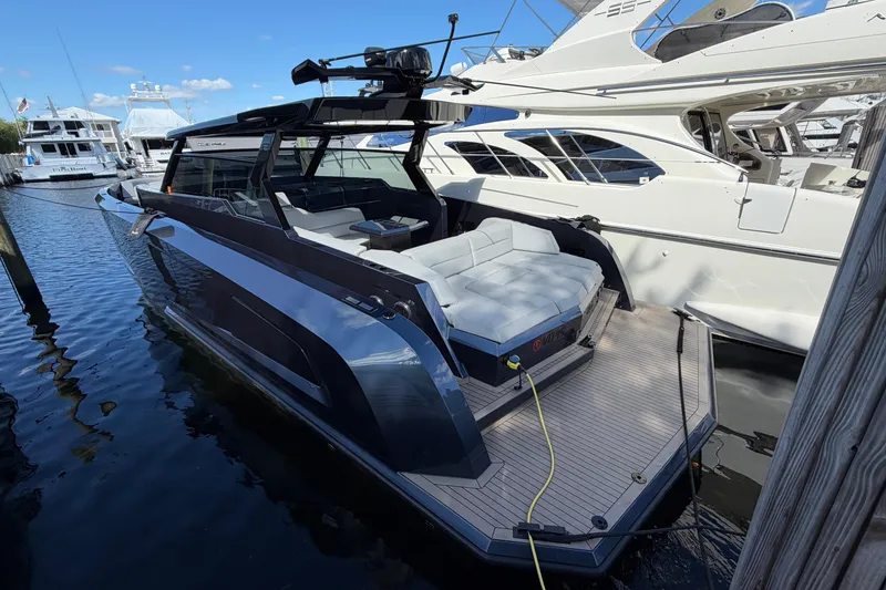 Slide: The Image of 2022 Vanquish VQ45 luxury yacht docked at marina, showcasing sleek design and spacious deck. - 1