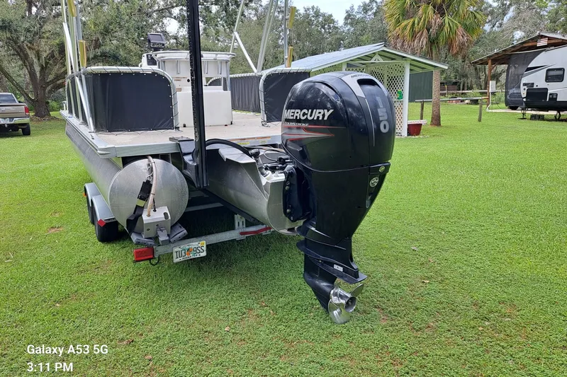 Slide: The Image of 2021 Avalon GS CC Fish 23' boat with Mercury outboard motor on grassy area. - 3