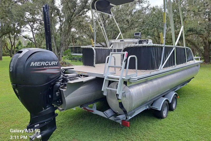 Slide: The Image of 2021 Avalon GS CC Fish 23' pontoon boat with Mercury outboard engine on trailer. - 4