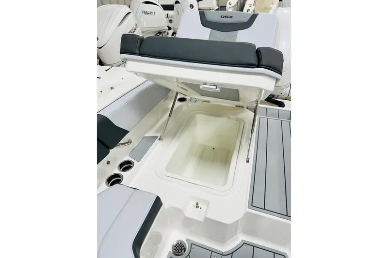 Slide: The Image of 2026 Chaparral 250 OSX boat with open storage compartment and sleek seating design. - 13