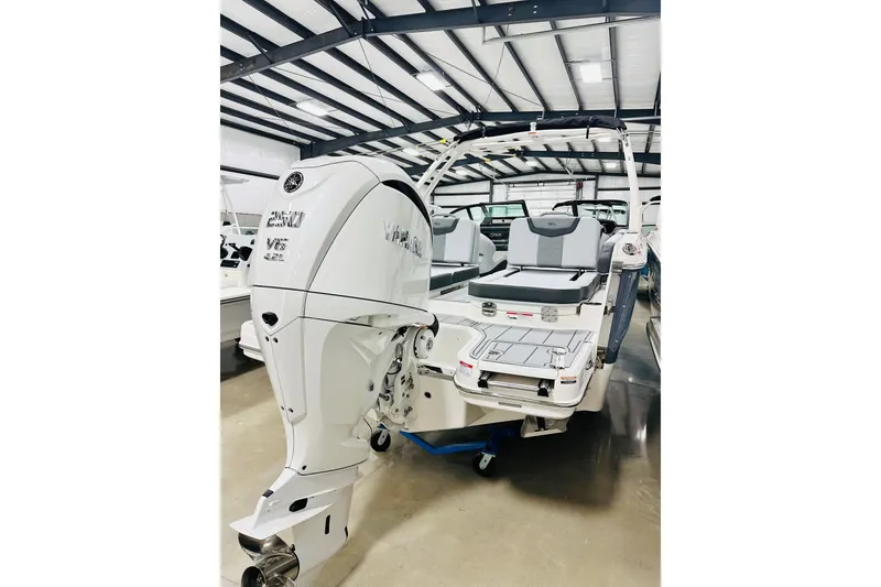 Slide: The Image of 2026 Chaparral 250 OSX boat with powerful outboard engine in showroom. - 16