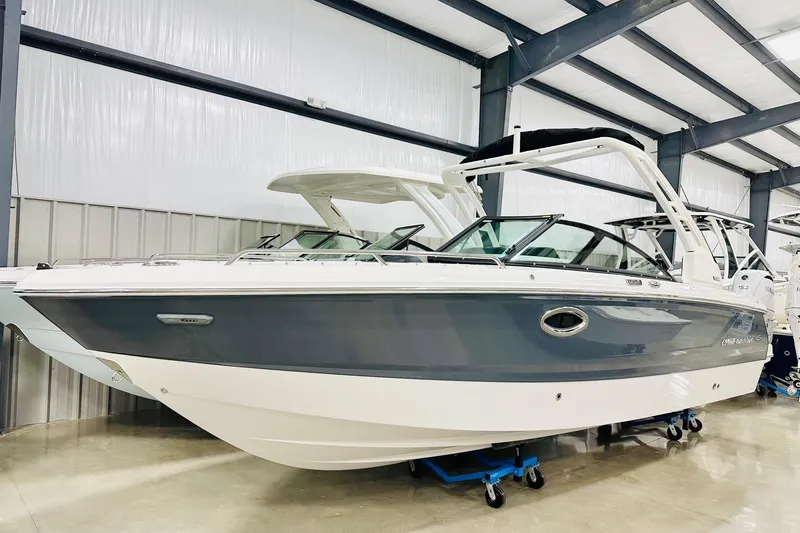 The Image of 2026 Chaparral 250 OSX boat in showroom, featuring sleek design and modern features. - 2