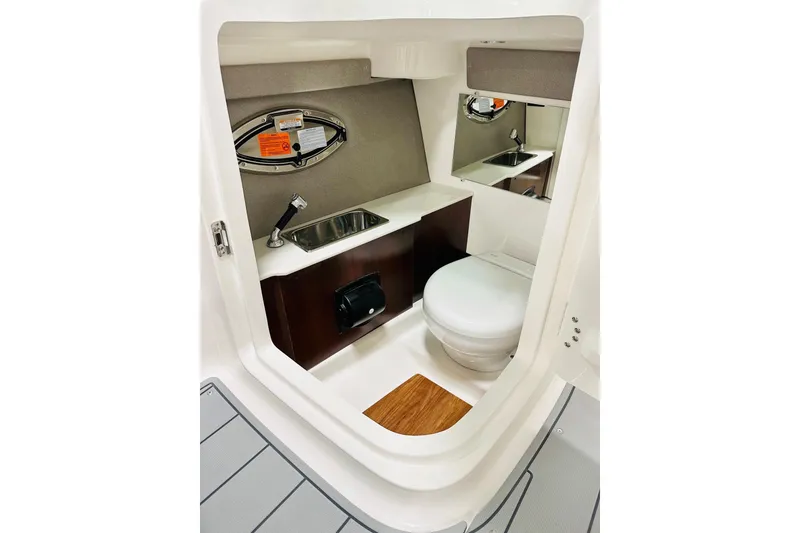 Slide: The Image of 2026 Chaparral 250 OSX boat interior with sink, toilet, and mirror. - 6