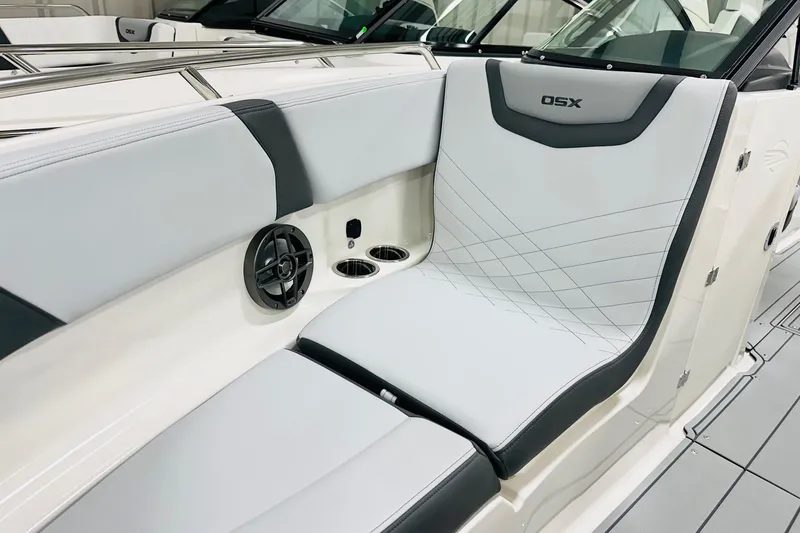 Slide: The Image of 2026 Chaparral 250 OSX boat interior with sleek seating and integrated speaker system. - 8