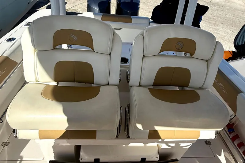 Slide: The Image of 2016 Edgewater 280CC boat seats with beige and tan upholstery, showcasing comfort and style. - 16