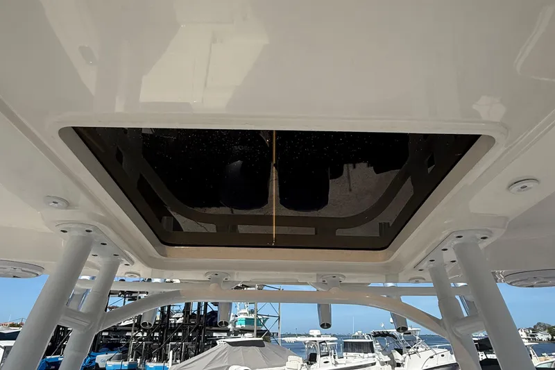 Slide: The Image of 2016 Edgewater 280CC boat roof hatch with marina view in background. - 18