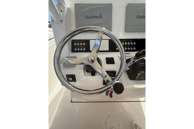 Slide: The Image of Steering wheel and controls of 2016 Edgewater 280CC boat with Garmin displays. - 20