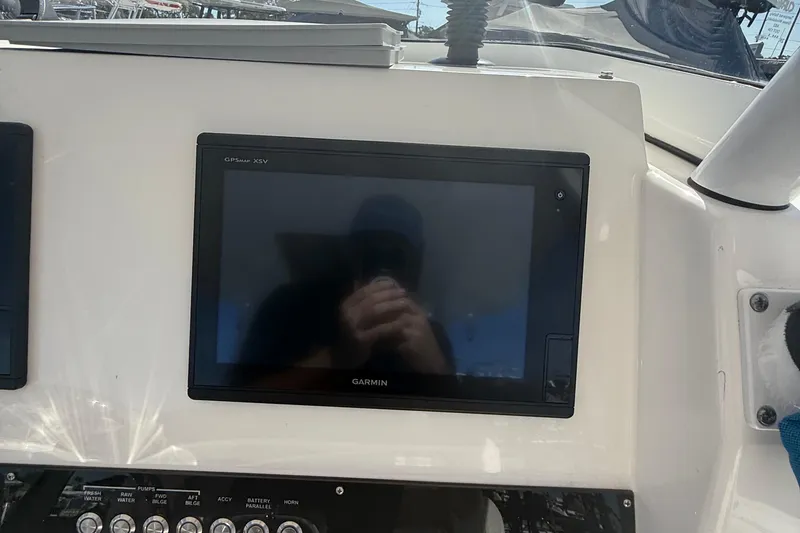 Slide: The Image of Garmin GPS display on 2016 Edgewater 280CC boat dashboard, reflecting sunlight. - 24