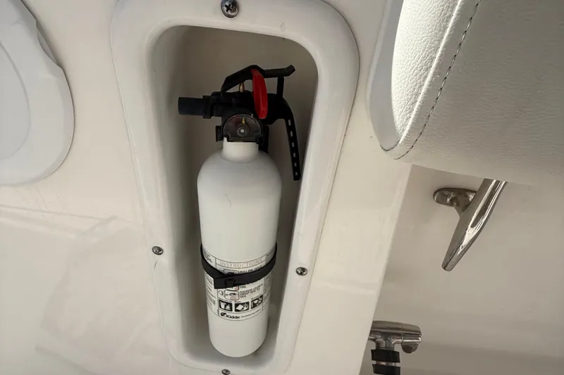 Slide: The Image of Fire extinguisher mounted on 2016 Edgewater 280CC boat, safety equipment detail. - 25