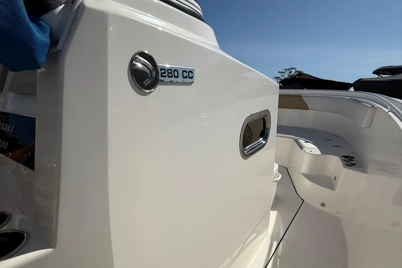 Slide: The Image of Edgewater 280CC 2016 boat interior with sleek white design and logo detail. - 27