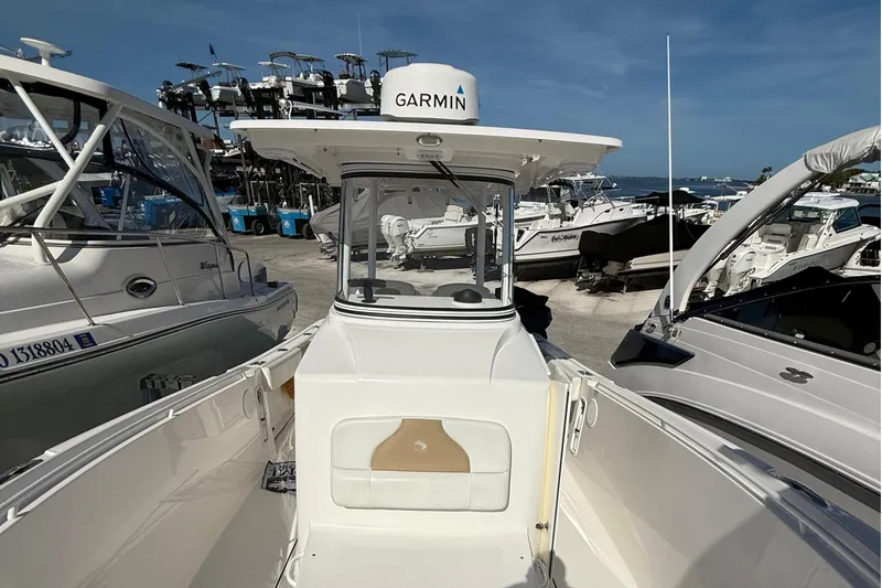 Slide: The Image of 2016 Edgewater 280CC boat docked among other vessels, featuring Garmin equipment. - 31