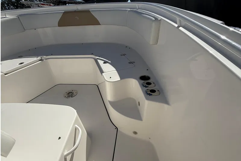 Slide: The Image of 2016 Edgewater 280CC boat interior, featuring spacious seating and cup holders. - 34