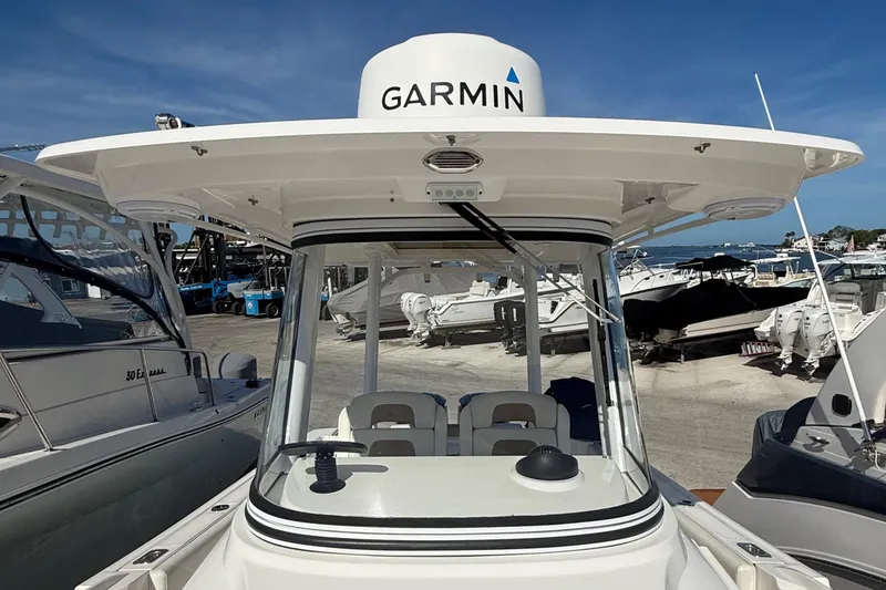 Slide: The Image of 2016 Edgewater 280CC boat with Garmin equipment, docked under clear blue skies. - 38