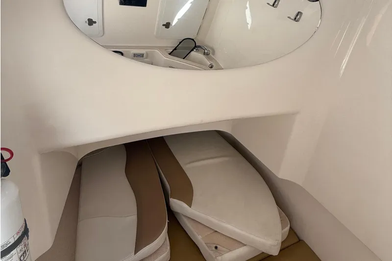 Slide: The Image of Interior cabin of 2016 Edgewater 280CC boat with cushions and mirror. - 40