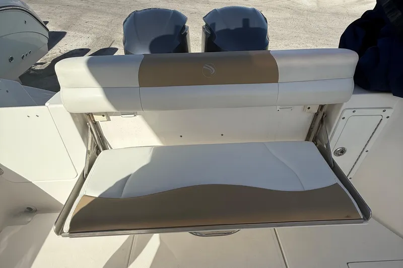 Slide: The Image of 2016 Edgewater 280CC boat with foldable rear seat and dual outboard motors. - 42
