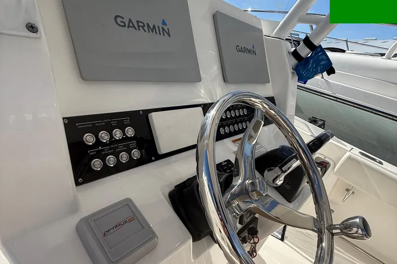 Slide: The Image of Edgewater 280CC 2016 boat dashboard with Garmin navigation and Optimus EPS system. - 44