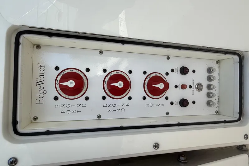 Slide: The Image of Control panel of a 2016 Edgewater 280CC boat with red switches and labels. - 45