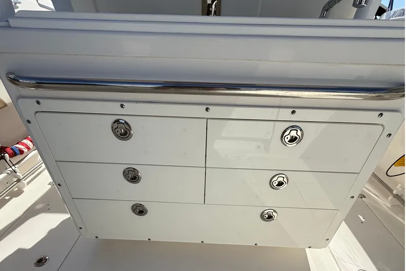 Slide: The Image of Storage compartment on a 2016 Edgewater 280CC boat with stainless steel handles. - 47