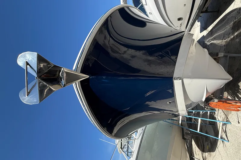 Slide: The Image of 2016 Edgewater 280CC boat with a sleek blue hull and stainless steel anchor. - 51