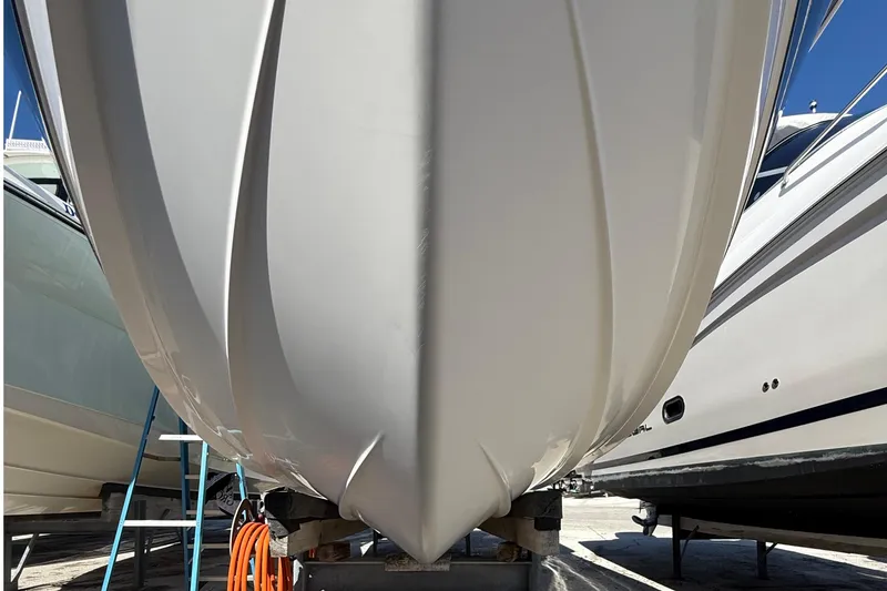 Slide: The Image of 2016 Edgewater 280CC boat hull on dry dock, surrounded by other boats. - 52