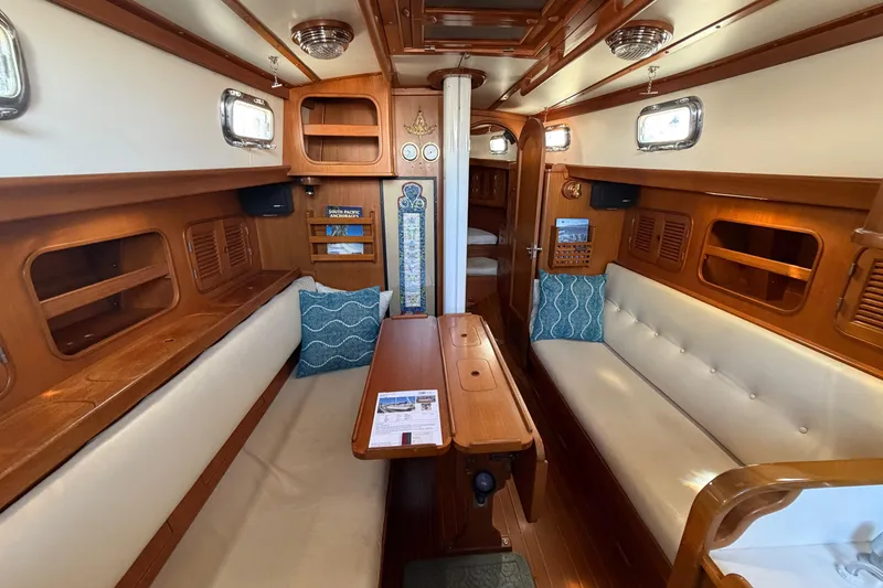 Slide: The Image of Interior of 1985 Mason 33 sailboat with wooden furnishings and cozy seating area. - 12