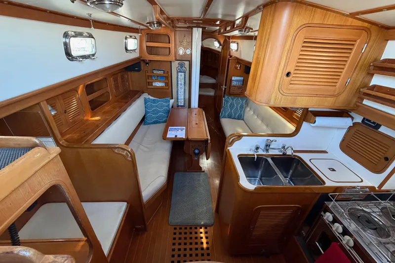 Slide: The Image of Interior of a 1985 Mason 33 sailboat with wood finish and compact kitchen. - 17