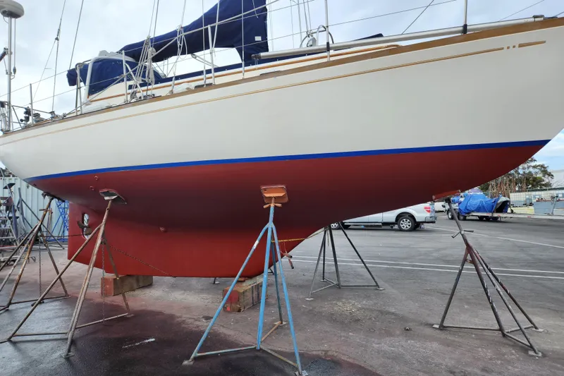 Slide: The Image of Sailboat Mason 33, 1985 model, on stands for maintenance in a boatyard. - 21