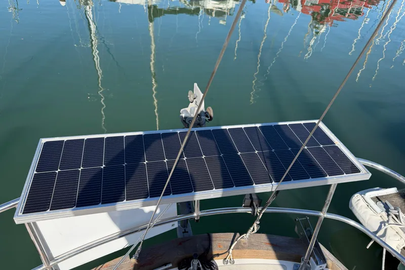 Slide: The Image of Solar panel on a 1985 Mason 33 sailboat, reflecting on calm water. - 28