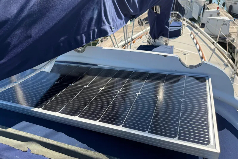 Slide: The Image of Solar panel on a 1985 Mason 33 sailboat deck, under blue canvas cover. - 29