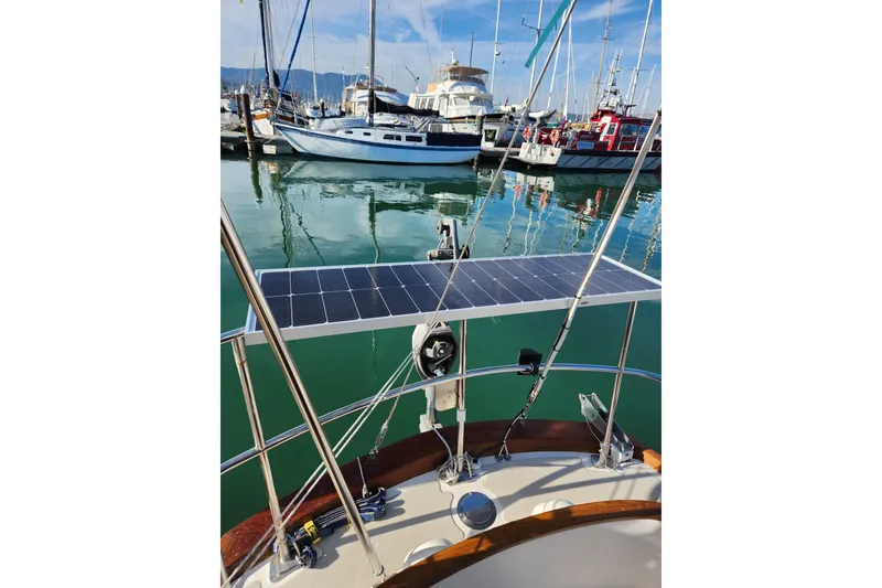Slide: The Image of Sailboat with solar panel docked in marina, Mason 33 model, 1985. - 8