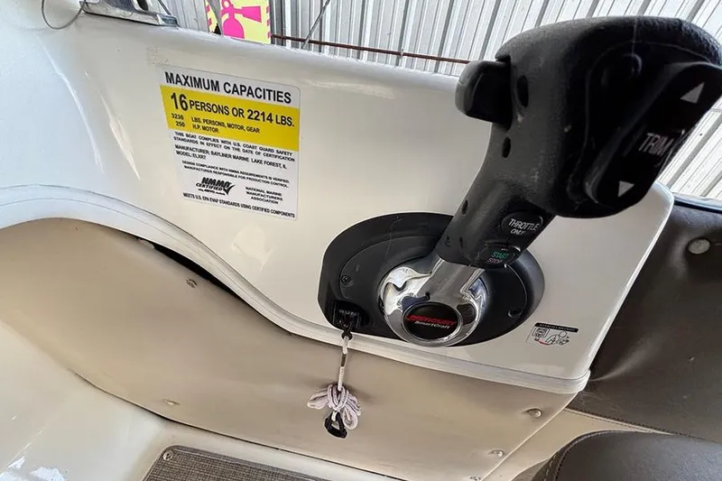 Slide: The Image of 2017 Bayliner Element XR7 boat throttle control and capacity label, 16 persons or 2214 lbs. - 10