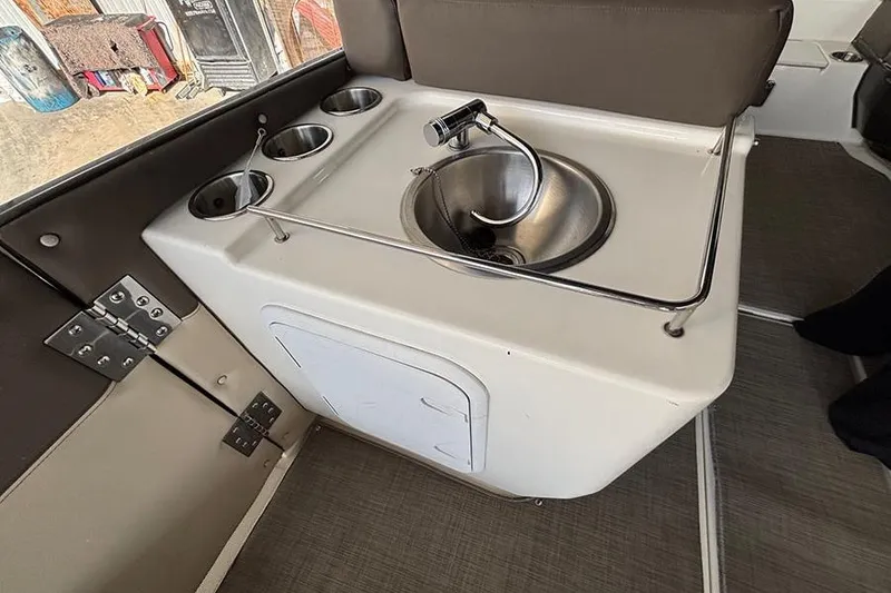 Slide: The Image of 2017 Bayliner Element XR7 boat interior with sink and cup holders. - 11